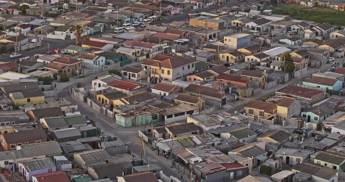 Cape Town South Africa Aerial v110 zoomed low drone flyover Around Khayelitsha township capturing the sprawling slums and makeshift shacks at sunset - Shot with Mavic 3 Pro Cine - Jan 11th 2024