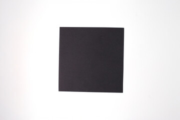 Fototapeta premium Square black paper on white background, basic material for kids paper bat craft, perfect for DIY tutorials, craft kits, educational content, hobby brands, and seasonal creative projects,