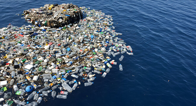 Massive Accumulation of Plastic Bottles and Waste Floating on Dark Blue Ocean Surface Forming a Floating Garbage Patch