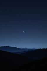 Crescent Moon Over Mountain Range at Night