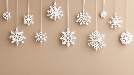 Beige background with ornate white snowflakes falling gently, evoking a minimalist and classy winter theme