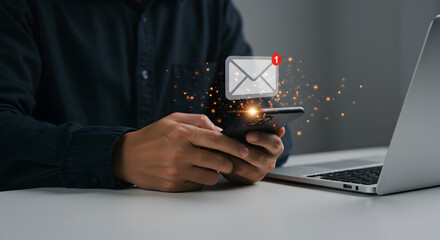 Person Using Smartphone Receiving Email with Laptop on Desk in White Background