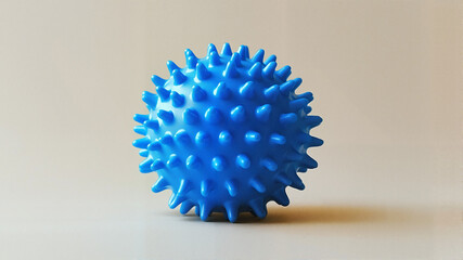 Blue spiky ball toy on a neutral background  