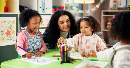 Drawing, helping and teacher with children in classroom for education, nursery and creative art. Growth, kindergarten and academy with woman and kids at school for learning and child development