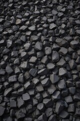 A massive pile of raw, black coal dominates the frame , black gold, environmental