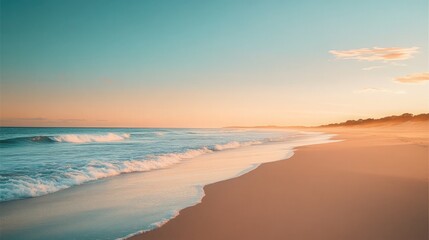 Obraz premium Serene beach with gentle turquoise waves and golden sand under pastel skies