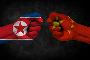 The Chinese and North Korean flags are both made of fist images. Concept image depicting a...