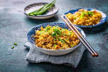 Indian Biryani, popular Indian rice dish served in small bowls with green onions