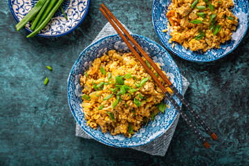 Indian Biryani, popular Indian rice dish served in small bowls with green onions
