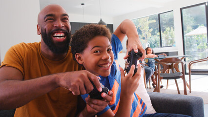 African American Family At Home With Son And Father Playing Video Game Together