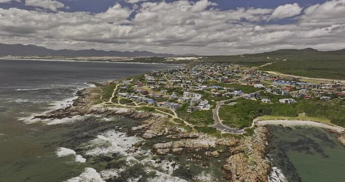 Gansbaai South Africa Aerial v28 reverse flyover Stanford's Cove Beach capturing De Kelders residential townscape, coastal shoreline and mountain landscape - Shot with Mavic 3 Pro Cine - Jan 8th 2024