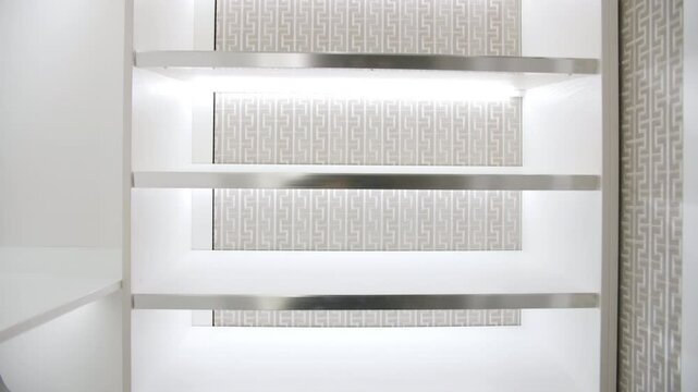 Bright white wardrobe with illuminated shelves