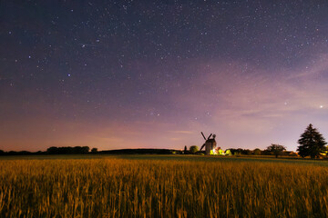 Old Paltrock windmill in Saalow at night with starry sky, Brandenburg, Germany
