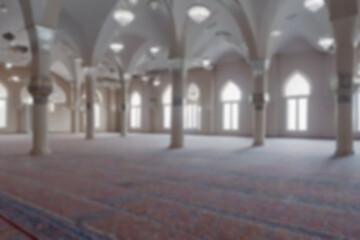 Blurry photo of mosque interior pillars and windows, suitable for various setting backgrounds or wallpapers