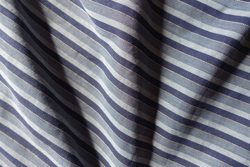 navy blue and grey striped cotton fabric in soft folds