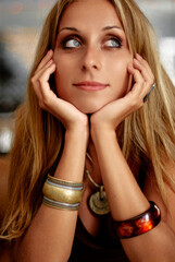 Portrait of a Thoughtful Woman Wearing Stylish Jewelry and Looking Up..