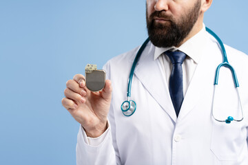 Doctor showing cardiac pacemaker device for heart disease treatment