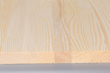 End of wooden panel made of softwood planks close-up