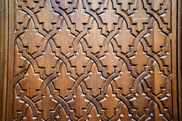Intricate geometric wooden pattern with interlocking star shapes.