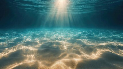 Obraz premium Beneath the tranquil surface of the ocean, sun rays pierce the water, illuminating the serene seabed and creating a captivating underwater landscape