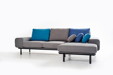 Contemporary Grey Sofa With Blue Cushions in Minimalist Setting..