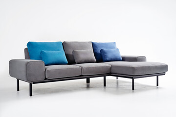 Modern Gray Sofa With Blue Cushions in Bright Minimalist Interior..
