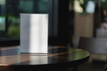 Stand Mock up Menu frame tent card blurred background design key visual layout A modern acrylic stand on the counter displays