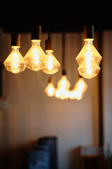 Decorative light bulbs illuminate a warm and inviting interior, showcasing a modern design. The glowing bulbs create an ambiance suited for relaxation, social gatherings, or a cozy room atmosphere.