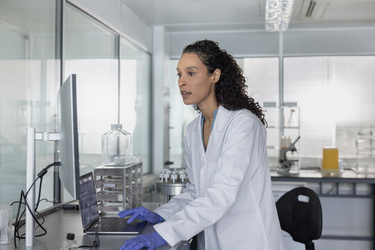 Woman scientist immersed in digital analysis in 