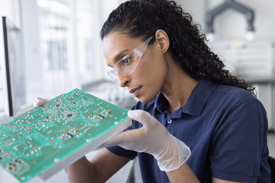 Technician Analyzing Circuit Board Components
