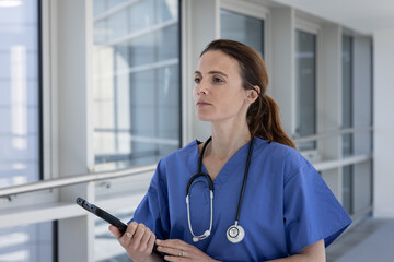 Female Doctor in Scrubs Holding Tablet
