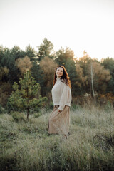 Obraz premium Woman walking in field at golden hour enjoying nature