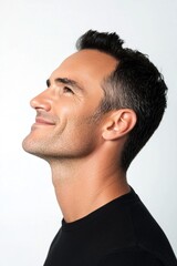 Fototapeta premium A glowing and peaceful man expressing warmth. Pure white solid background. Concept art of style for aging men. Modish men's mid fade haircut - midlife white man with black hair.