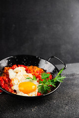 Fried egg tomatoes shakshuka vegetable dish appetizer fresh delicious gourmet food background on the table rustic food top view copy space vegetarian  food