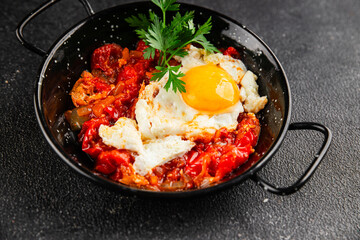 Fried egg tomatoes shakshuka vegetable dish appetizer fresh delicious gourmet food background on the table rustic food top view copy space vegetarian  food