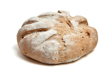 Freshly baked wholegrain artisan bread loaf with a golden-brown crust, deep scoring, and a light flour dusting. Traditional handcrafted texture, isolated on white