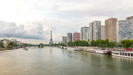 Fototapeta premium The Statue of Liberty and the Eiffel Tower timelapse hyperlapse with modern buildings. Paris, France