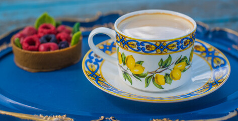 Lemon tea cup and dessert on blue tray, cozy lifestyle setting