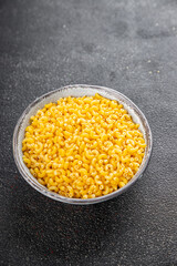 Macaroni pasta raw coquillette appetizer dish organic product fresh tasty gourmet food background on the table rustic food top view copy space