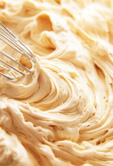 Buttercream in mixing bowl with metal whisk, suitable for baking theme