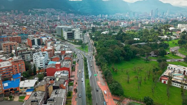 Aerial drone fly traffic at 53 street and colsubsidio club in Bogot&aacute; city Colombia with skyscrapers background, Altiplano mountain town