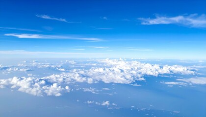 Naklejka premium Stunning aerial view of fluffy white clouds scattered across a vast expanse of clear blue sky.