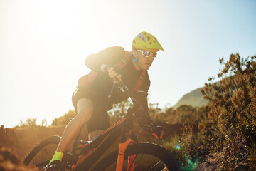 Bike, concentration and sports with man in mountains for outdoor adrenaline, adventure or training....