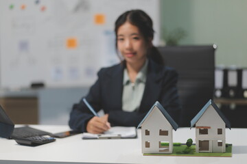 Real estate agents explain models of housing estates in projects to elaborate to clients,...
