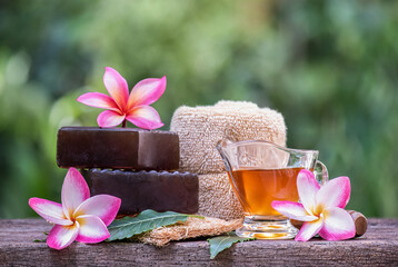 Glycerin soap mixed with neem leaves extract and honey on natural background.