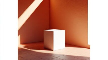 Empty white cube pedestal illuminated by natural light in a coral room.