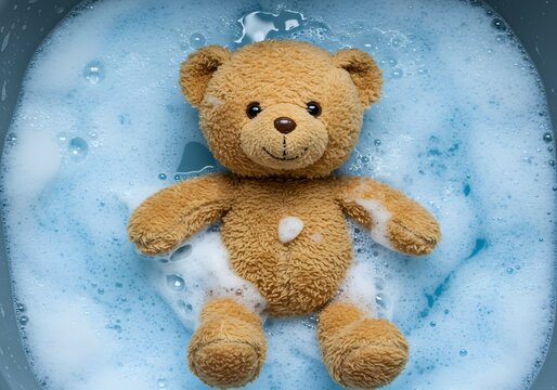 Naklejki Cute Teddy Bear Soaking in Soapy Water for Washing.