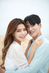 Young Asian Couple Embracing on Beach Shore in Summer