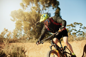 Bike, speed and sports with man in mountains for outdoor adrenaline, adventure or training. Exercise, fitness and trail riding with person cycling off road for challenge, competition or performance