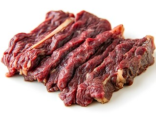 Obraz premium Freshly cut slices of raw red meat lie neatly arranged on a pristine white background ready for cooking.